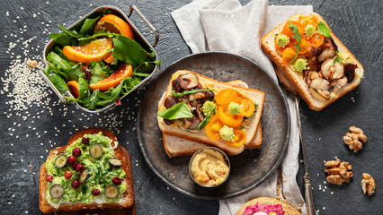 Vegan toast with avocado,mushroom and fresh salad on dark background. Vegetarian food concept