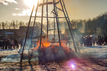 Burning effigy Maslenitsa at sunset, Russian spring holiday Maslenitsa
