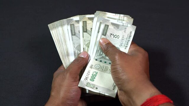 A man counting Indian rupees.