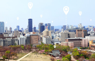 Network connection concept. Aerial view on Osaka with white location pin. Global positioning system...
