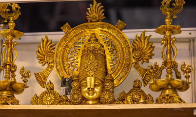 Brass metal art, Handmade Indian Lord Tirupati Balaji sculpture souvenir made with brass with plain background. Selective focus.