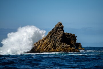 wave crashing over rock in the ocean off the australian coastline