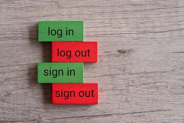 Top view image of wooden blocks with text LOG IN, LOG OUT, SIGN IN, SIGN OUT.