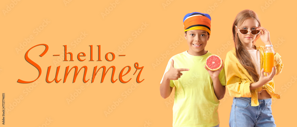 Wall mural little children with bottle of fresh citrus juice and grapefruit slice on orange background