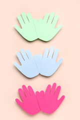 Colorful paper palms for Friendship Day on beige background