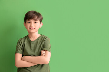 Little boy on green background. Children's Day celebration