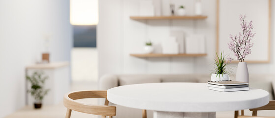 A space for displaying products on a white round table in a cozy contemporary living room.