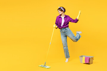 Full body young woman wear purple shirt casual clothes do housework tidy up hold in hand mop bucket...