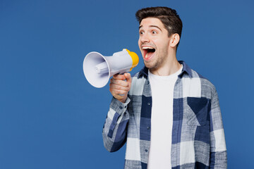Young surprised man he wear shirt white t-shirt casual clothes hold in hand megaphone scream announces discounts sale Hurry up isolated on plain blue cyan background studio portrait Lifestyle concept - 772795853