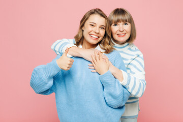 Elder happy parent mom 50s years old with young adult daughter two women together wear blue casual...