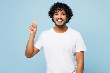 Young smart proactive Indian man wear white t-shirt casual clothes holding index finger up with...