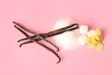Composition with vanilla sticks, sugar and flower on pink background