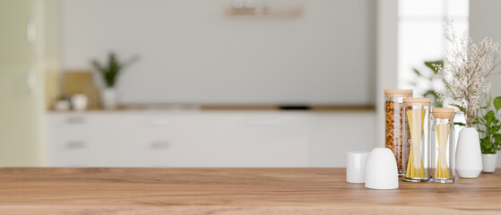 A space for display products on a wooden kitchen tabletop in a modern white kitchen.