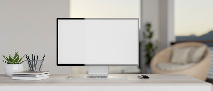 A modern white home office features a white-screen PC computer mockup and accessories on a desk.