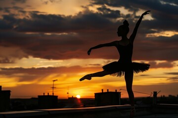 silhouette of ballerina at sunset on rooftop