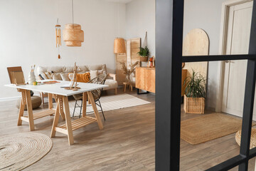 Interior of light room with wind chime and artist's workplace