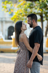 Close-up of a young couple gazing at each other while visiting the city of Valladolid in Mexico.