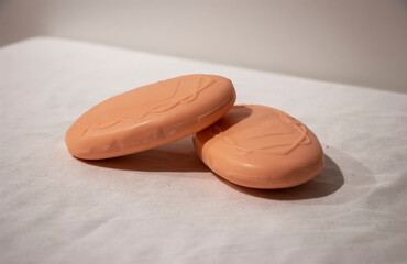 Two orange soaps are on a table