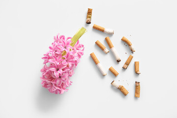 Lungs made with flowers and cigarette butts on white background, closeup. Stop smoking concept.