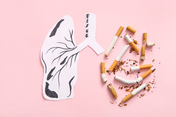 Paper lungs with cigarette butts on pink background. Stop smoking concept.
