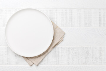 Empty plate on wooden table, overhead view