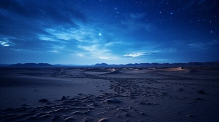 A desert landscape with a clear blue sky and stars