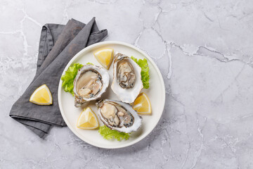Fresh oysters with lemon on plate