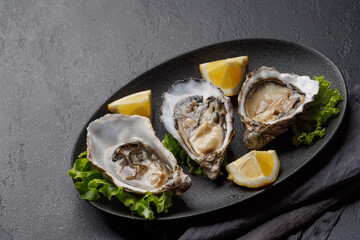 Fresh oysters with lemon on plate