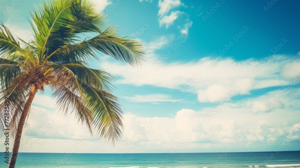 Poster a palm tree is standing on a beach with a clear blue sky