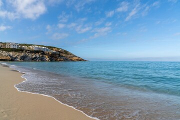 golden sand beach and clear turquoise waters at Cala Mesquida beach in eastern Majorca