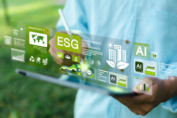 ESG concepts for environment, society and governance. Businessman uses iPad to analyze ESG in...