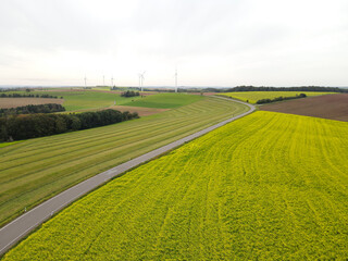 View from above of a farmland with a road and electricity generatos 