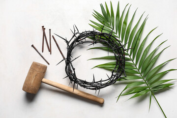 Crown of thorns with palm leaf, nails and hammer on white grunge background. Good Friday concept