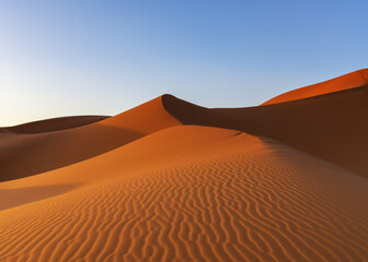 view of the sand dunes at Erg Chebbi in Morocco in warm evening light