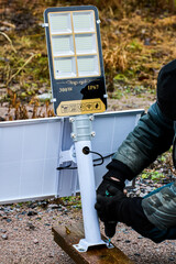 Assembly of fully autonomous, standalone LED street lighting, construction worker install support...