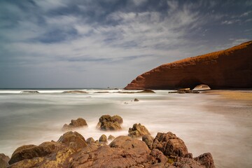long exposure view of the beach and rock arch at Legzira on the Atlantic Coast of Morroco