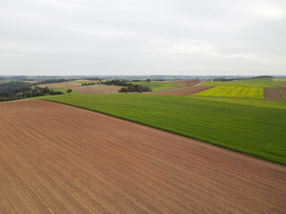 Fototapeta na wymiar Aerial view of a farmland with country fields and a road 