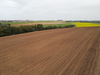 Aerial view of a farm field with soil in the countryside