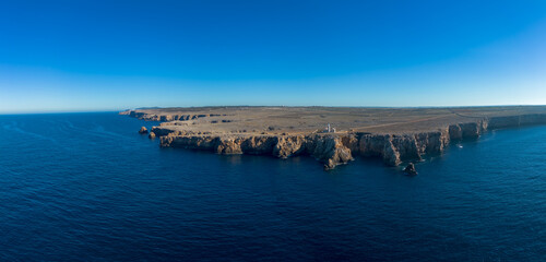 drone panorama view of the Punta Nati lighthouse and coastal cliffs in northwestern Menorca