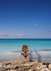 old dock leads out into the turquoise waters of the Ses Illetes Beach in northern Formentera