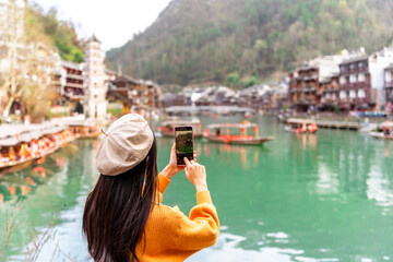 Young female tourist taking a photo of the Feng Huang Ancient Town, The famous tourist destination at Hunan Province, China - 772831679