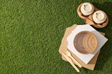 Ecological packaging for food delivery, on the grass.