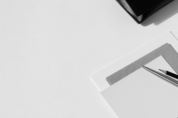 Monochrome Mockup of Office Stationery, Notebook, Cards, Envelopes on White Background with Copy Space.