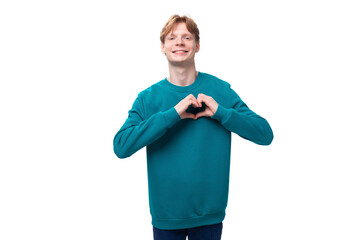 young happy man with red hair dressed in a blue sweater
