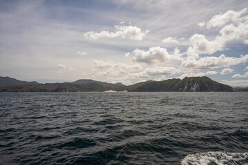 sailor sailing a yacht with a sail on a beautiful day exploring the australian coastline of tasmania