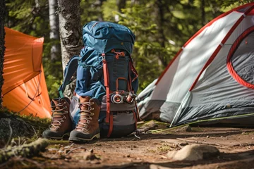 Foto op Canvas backpack and hiking boots outside tent in alpine forest © studioworkstock