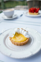 A Moment of Delight: Treating Yourself to a Coffee Break Delicacy - Lemon Tart - Stock Photo for Culinary Connoisseurs