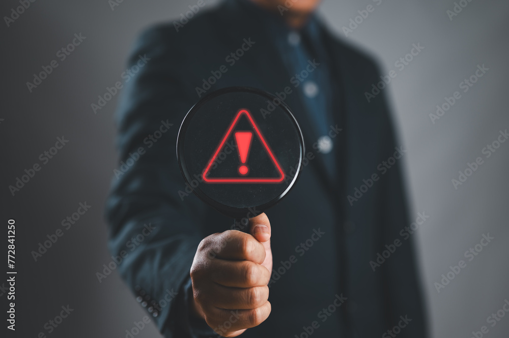 Aufkleber Businessman using laptop showing warning triangle and exclamation sign icon Warning of dangerous problems server error