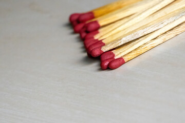 A pile of match sticks isolated on a wooden surface