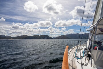 exploring the oceans and world while sailing a yacht with a sail on a beautiful day exploring the australian coastline of tasmania